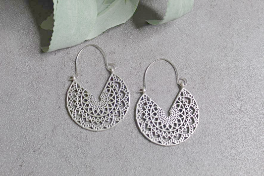 Silvertone dangle earrings with floral detail